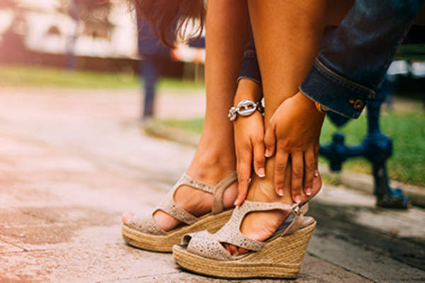 Woman wearing wedge sandals in the park.