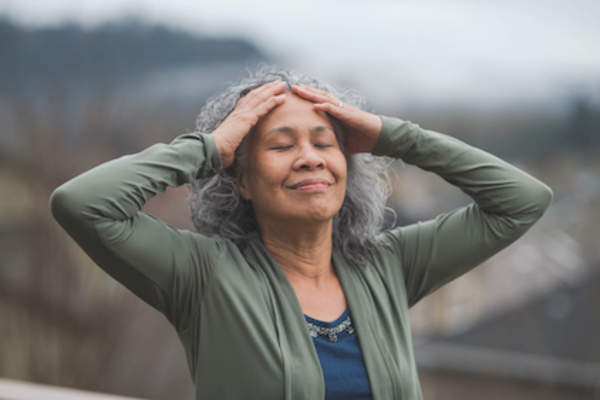 Woman breathing deeply outside