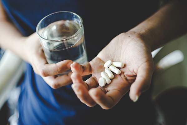 Hand holding pills