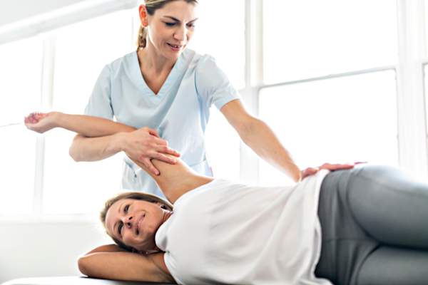 physical therapist working with client