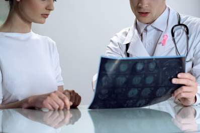 Oncologist explaining results of mammogram to patient.