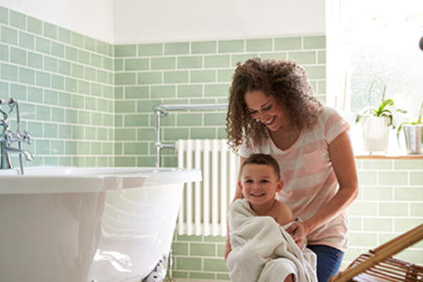 Mom helping her son dry off after his bath.