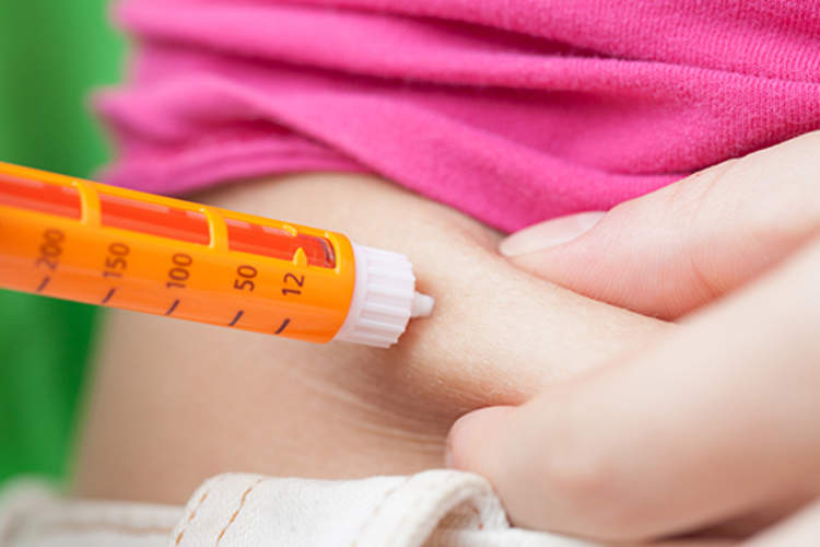 Injection shot by syringe in abdomen