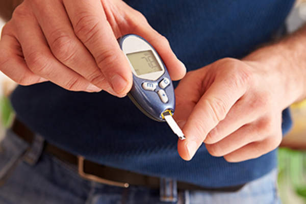 Diabetic man checking his blood sugar levels.