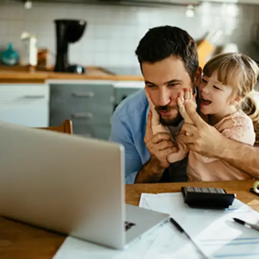 Father on laptop with daughter