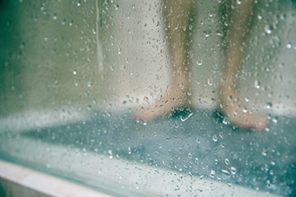 Standing in a shower.