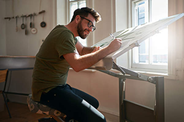 Man working in studio on an easel.