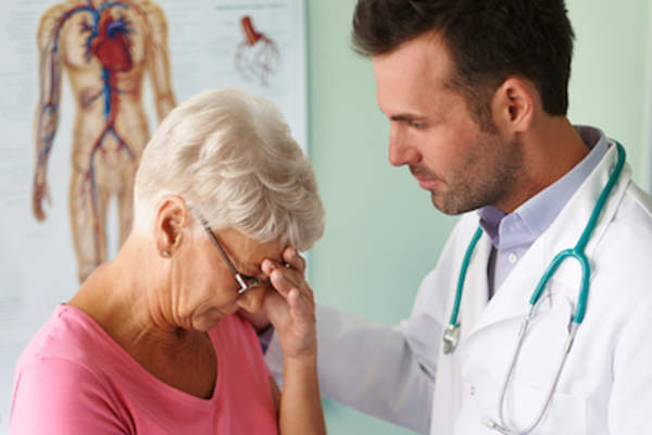 Older patient talking to doctor about feelings of sadness