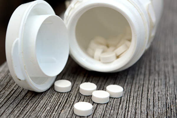 Bottle of melatonin bottles spilling out.