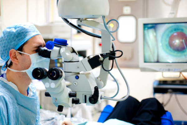 Surgeon performing eye surgery.