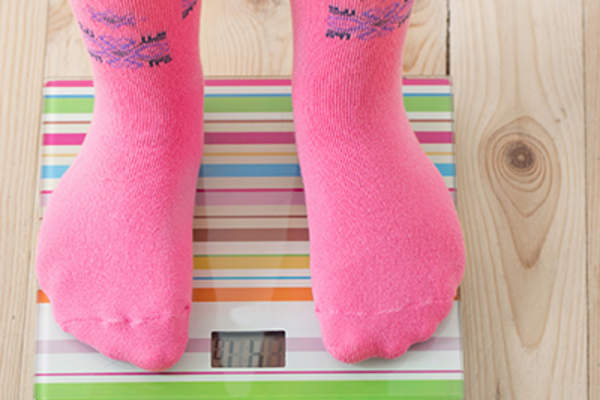 Standing on a scale.