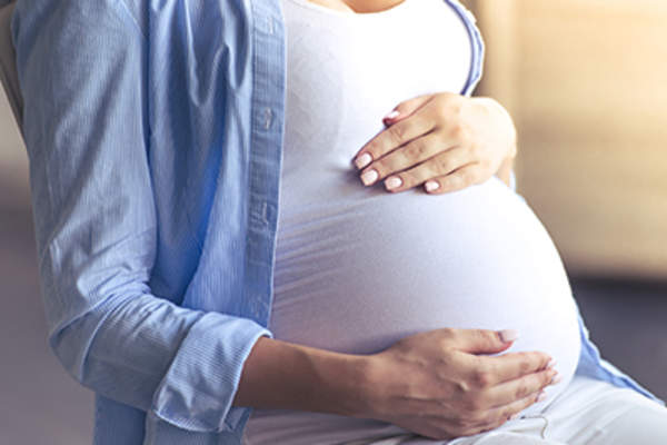 Pregnant woman feeling stomach.