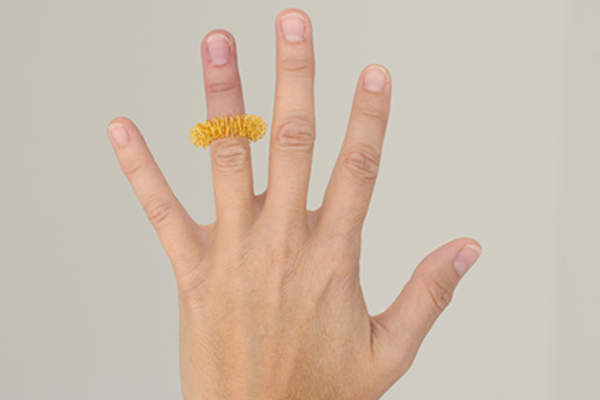 Massage ring on woman's finger.