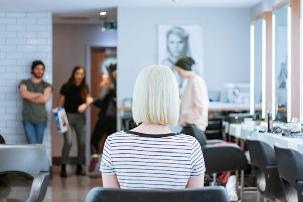 woman with bleached hair from behind at hair salon