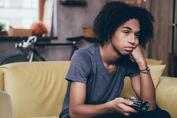 teenage boy watching television image