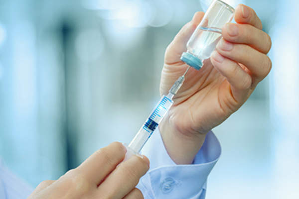 Doctor preparing an injection medication.