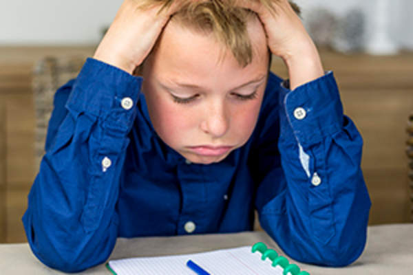 boy having trouble with homework image