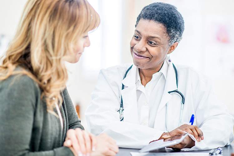 Woman talking to a doctor.