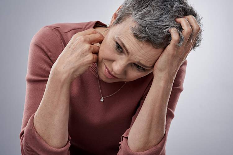 Anxious woman with itchy skin.