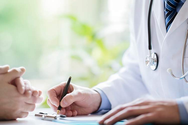 Doctor and patient taking notes during appointment