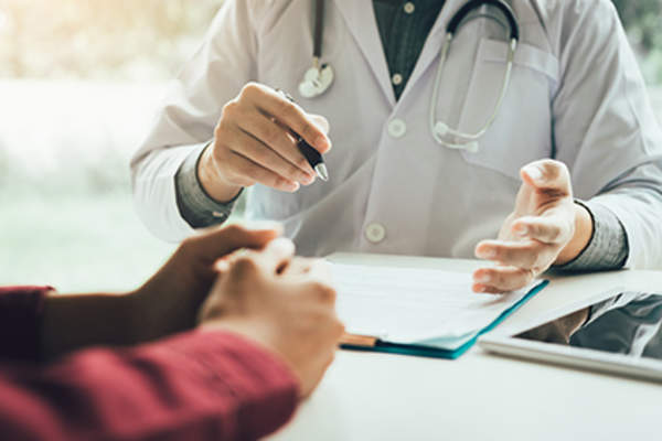 Doctor explaining why some patients respond better to adjuvant therapy than others.
