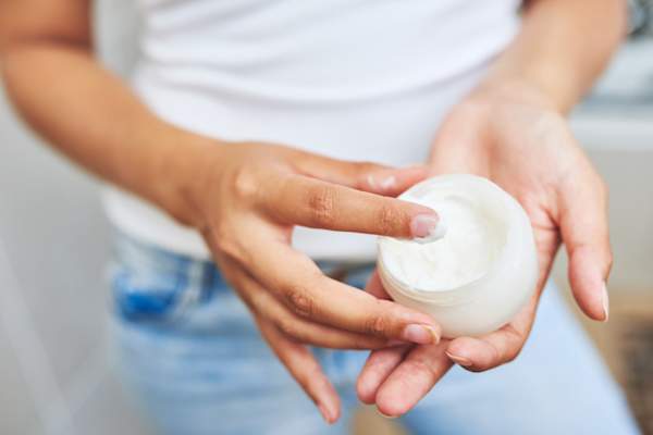 woman using moisturizer