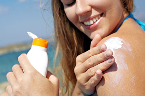 Woman applying sunscreen