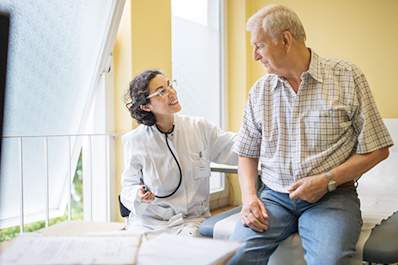Doctor smiling at a senior patient.