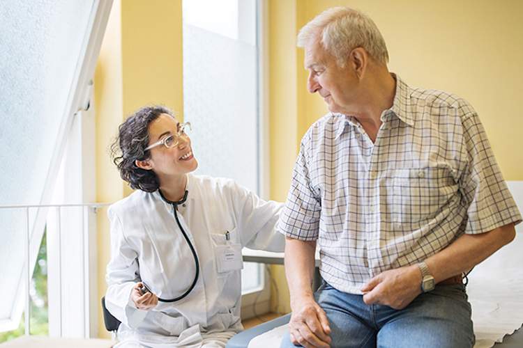 Doctor smiling at a senior patient.