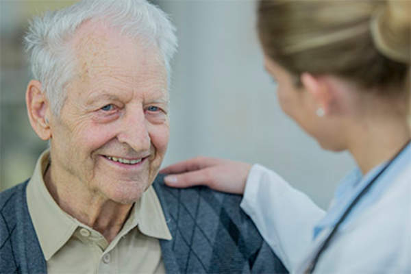 Older man with supportive doctor.