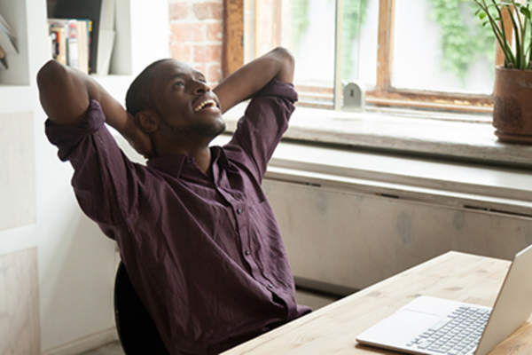 Man relaxing at his desk.