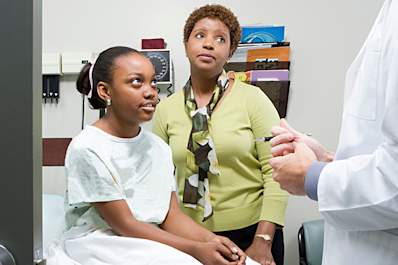 Pre-teen girl with her mother at the doctor's.