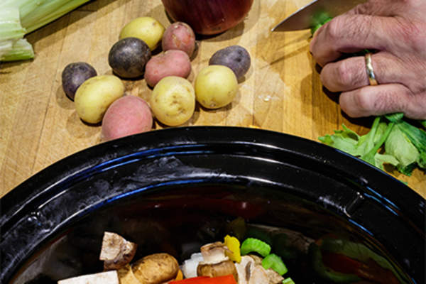 Making a crockpot meal.