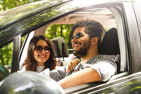 Couple smiling during a drive.