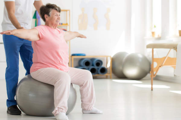 Older woman working with physical therapist
