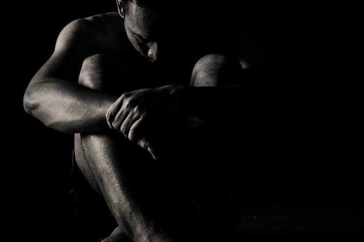 black and white photo of depressed man