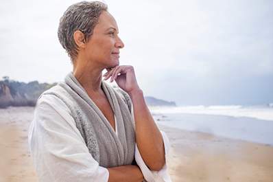 Senior woman contemplating on the beach.