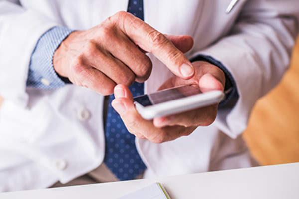 Doctor using smartphone, medical technolgy.