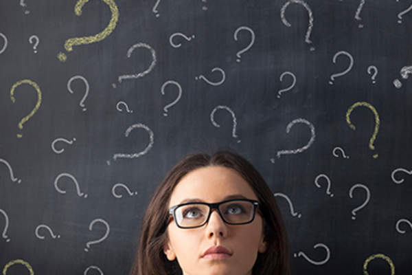 Woman with chalk question marks around her head.