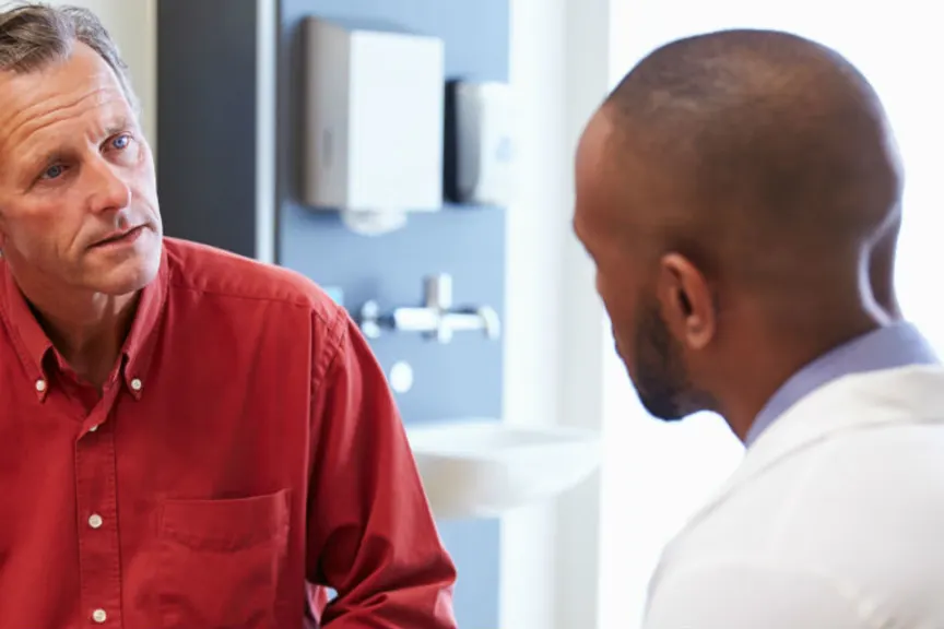 Man Talking with doctor in doctors office