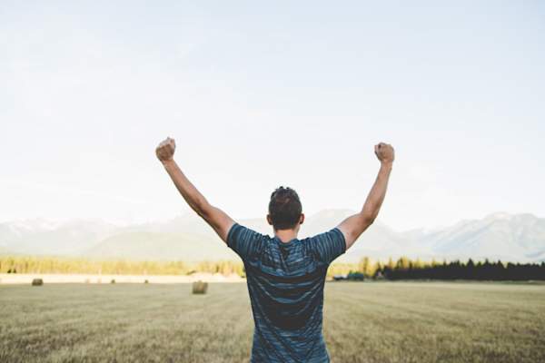 man with arms in the air