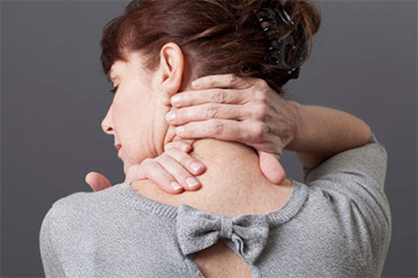 Woman massaging her neck muscles.