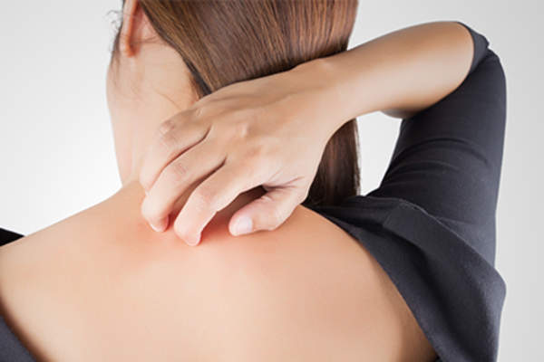 Woman scratching an itch.