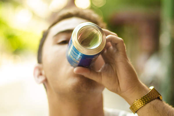 teenage boy drinking beer image