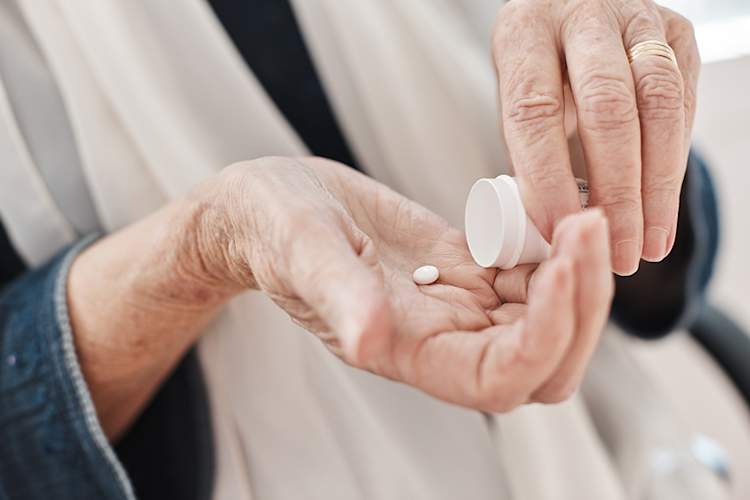 Senior woman taking a pill