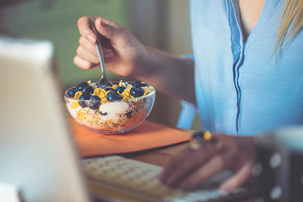 Woman eating cereal.
