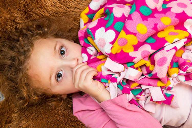Little girl with a security blanket.