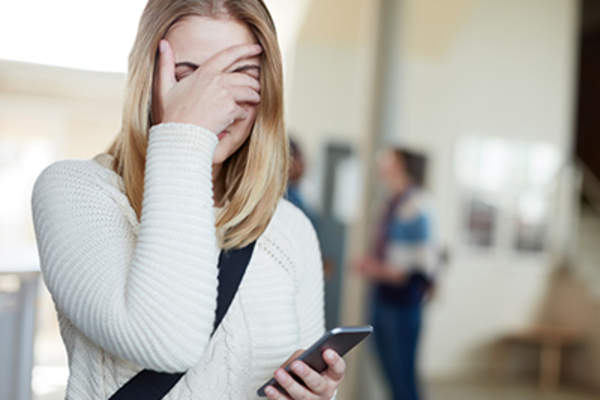 Embarrassed girl covering her face.