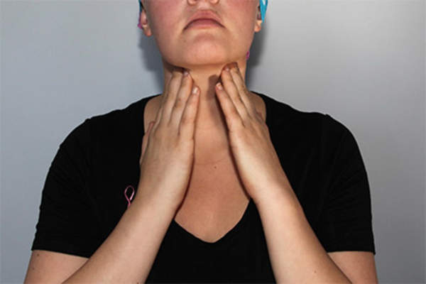 Woman checking lymph nodes in neck.