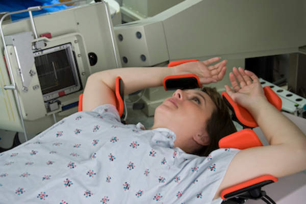 Woman set up for radiation therapy.
